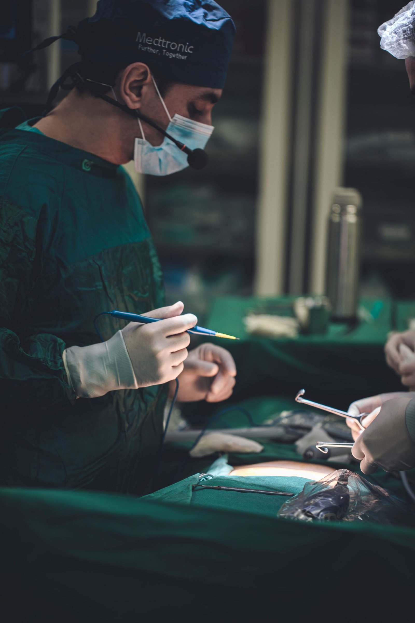 Surgeons meticulously operating in an OR, emphasizing teamwork and precision.